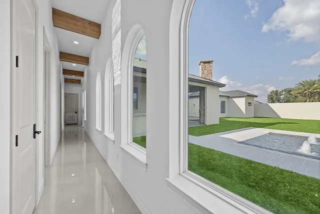 Mediterranean Custom Home — Hallway overlooking the pool