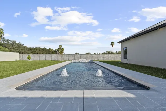 Mediterranean Custom Home — Pool looking back to the house