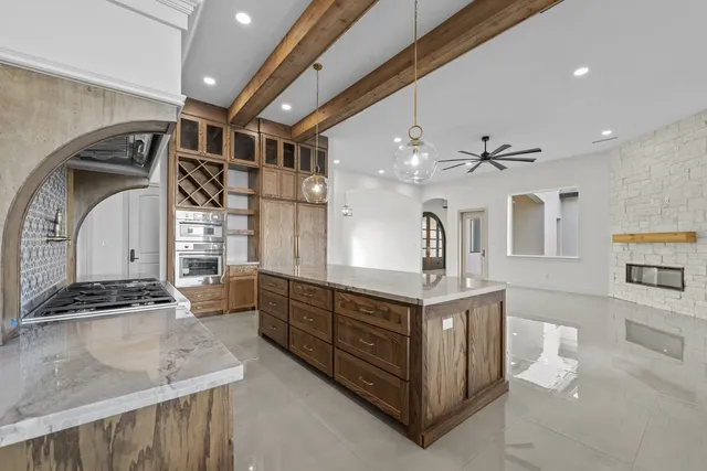 Mediterranean Custom Home — Kitchen range under an arched hood