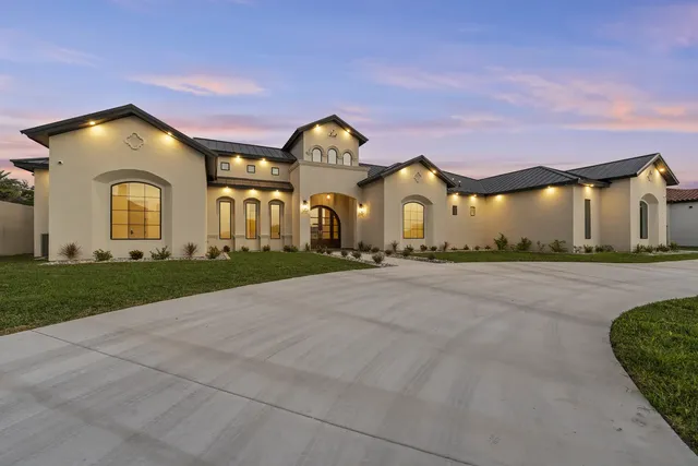 Mediterranean Custom Home — Front elevation at dusk, wide